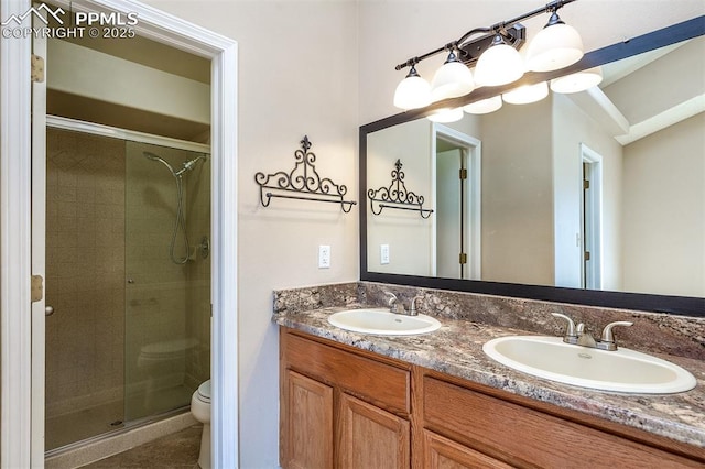 7435 Julynn Rd, Colorado Springs, CO 80919 - full bathroom featuring a stall shower, double vanity, and toilet