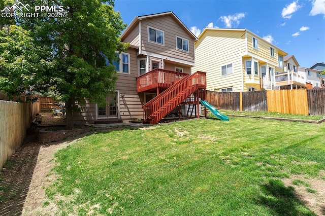 7435 Julynn Rd, Colorado Springs, CO 80919 - rear view of house with a playground and a deck