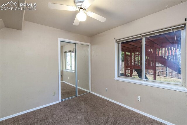 7435 Julynn Rd, Colorado Springs, CO 80919 - unfurnished bedroom with carpet, baseboards, a closet, and ceiling fan