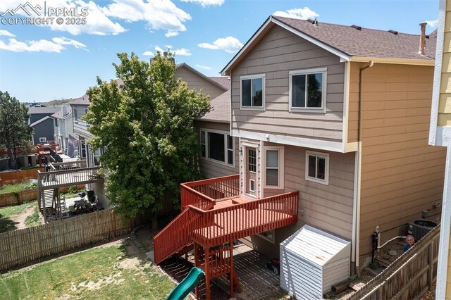 7435 Julynn Rd, Colorado Springs, CO 80919 - back of house with a wooden deck, a fenced backyard, central AC, and stairway