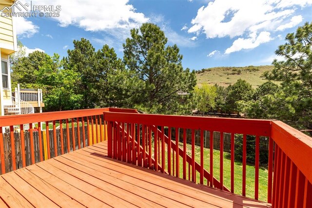 7435 Julynn Rd, Colorado Springs, CO 80919 - wooden deck featuring a yard