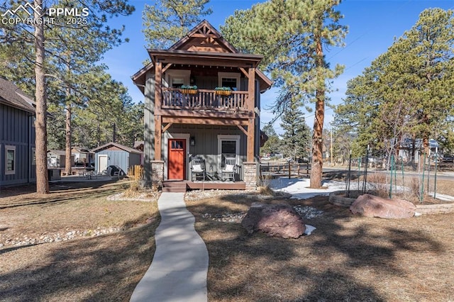404 S Willow St, Woodland Park, CO 80863 - view of front of house featuring a balcony, board and batten siding, and a porch