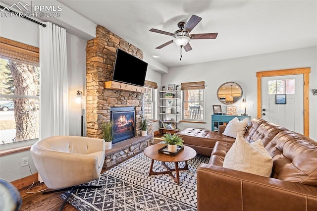 404 S Willow St, Woodland Park, CO 80863 - living room with a fireplace, wood finished floors, a ceiling fan, and baseboards