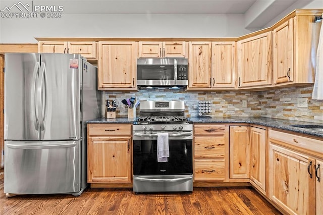 404 S Willow St, Woodland Park, CO 80863 - kitchen featuring appliances with stainless steel finishes, light brown cabinets, dark wood finished floors, and backsplash