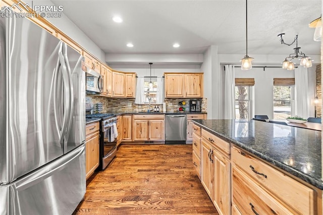 404 S Willow St, Woodland Park, CO 80863 - kitchen featuring appliances with stainless steel finishes, light brown cabinetry, dark wood-type flooring, healthy amount of natural light, and recessed lighting
