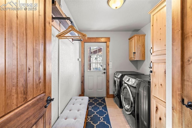 404 S Willow St, Woodland Park, CO 80863 - washroom with independent washer and dryer, cabinet space, light wood-style floors, and a textured ceiling
