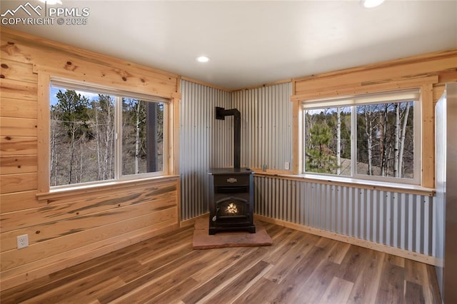 621 Yorktown Rd, Cripple Creek, CO 80863 - unfurnished living room featuring a wood stove, wood finished floors, recessed lighting, and wooden walls