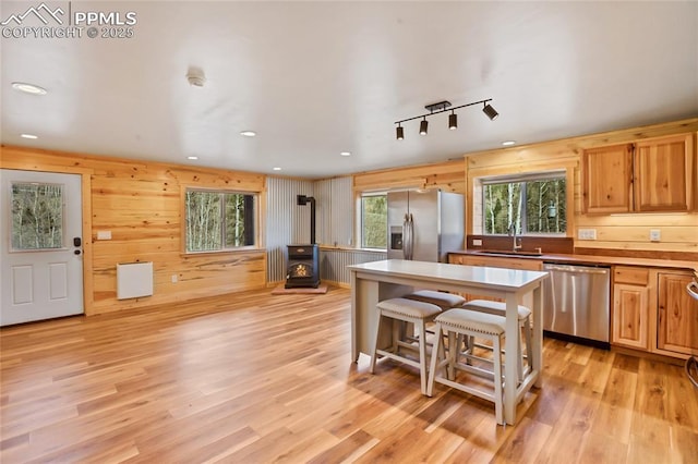621 Yorktown Rd, Cripple Creek, CO 80863 - kitchen with appliances with stainless steel finishes, a wood stove, a sink, healthy amount of natural light, and recessed lighting