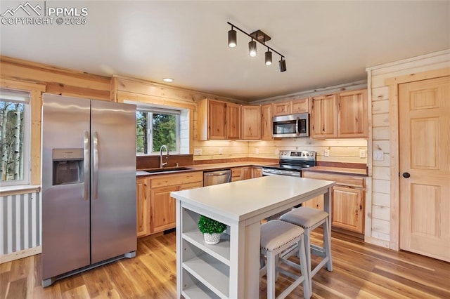 621 Yorktown Rd, Cripple Creek, CO 80863 - kitchen featuring stainless steel appliances, a sink, open shelves, and light wood-type flooring