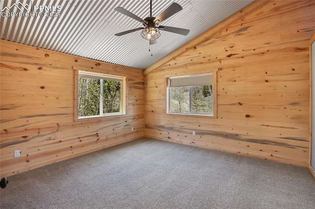 621 Yorktown Rd, Cripple Creek, CO 80863 - unfurnished room with lofted ceiling, plenty of natural light, wooden walls, carpet floors, and a ceiling fan