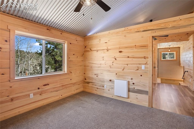 621 Yorktown Rd, Cripple Creek, CO 80863 - carpeted spare room with a ceiling fan, wood walls, and lofted ceiling