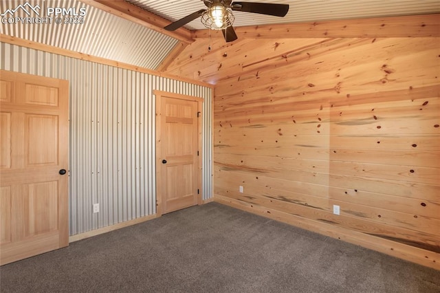 621 Yorktown Rd, Cripple Creek, CO 80863 - unfurnished room featuring dark colored carpet, ceiling fan, vaulted ceiling, and wood walls