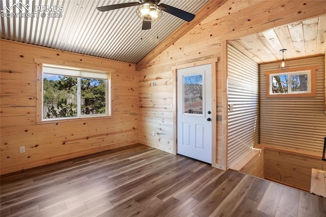 621 Yorktown Rd, Cripple Creek, CO 80863 - empty room with wooden walls, vaulted ceiling, wood finished floors, a ceiling fan, and wood ceiling