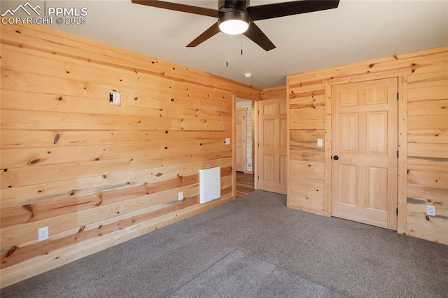 621 Yorktown Rd, Cripple Creek, CO 80863 - unfurnished bedroom with wooden walls, carpet, and ceiling fan