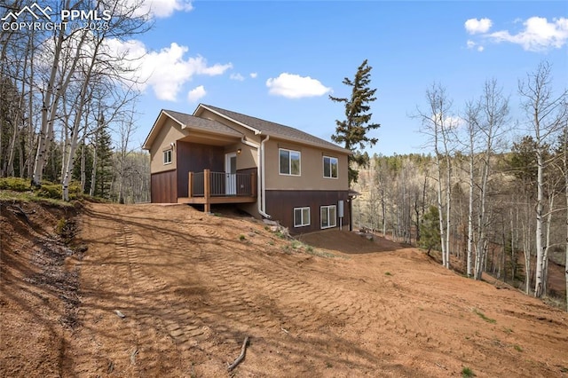 621 Yorktown Rd, Cripple Creek, CO 80863 - view of side of home with a deck and a view of trees