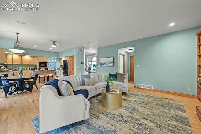 8110 Routt Ct, Colorado Springs, CO 80919 - living room with light wood-type flooring, a ceiling fan, and recessed lighting