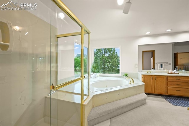 8110 Routt Ct, Colorado Springs, CO 80919 - bathroom featuring vanity, a bath, a marble finish shower, and recessed lighting