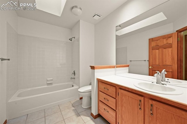 8110 Routt Ct, Colorado Springs, CO 80919 - bathroom featuring tile patterned flooring, bathing tub / shower combination, vanity, and a skylight