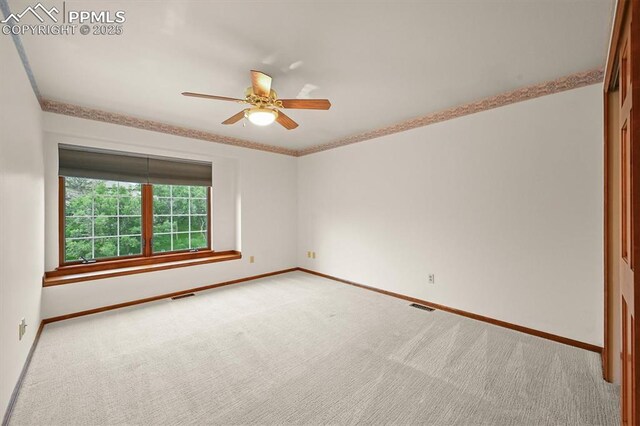 8110 Routt Ct, Colorado Springs, CO 80919 - empty room with carpet, a ceiling fan, and crown molding