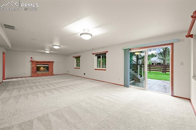 8110 Routt Ct, Colorado Springs, CO 80919 - unfurnished living room with light carpet and a brick fireplace