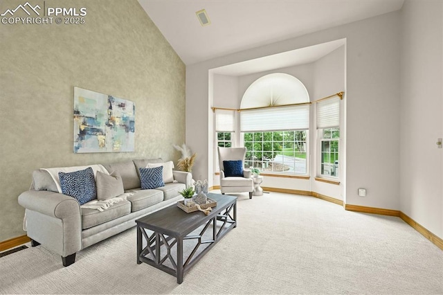 8110 Routt Ct, Colorado Springs, CO 80919 - carpeted living room with baseboards and high vaulted ceiling