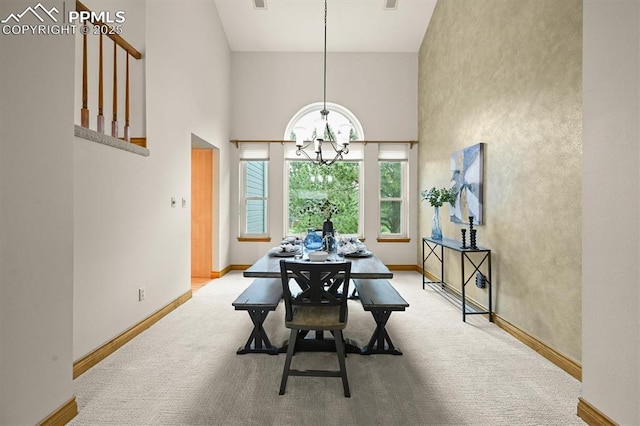 8110 Routt Ct, Colorado Springs, CO 80919 - carpeted dining area with a chandelier and a towering ceiling