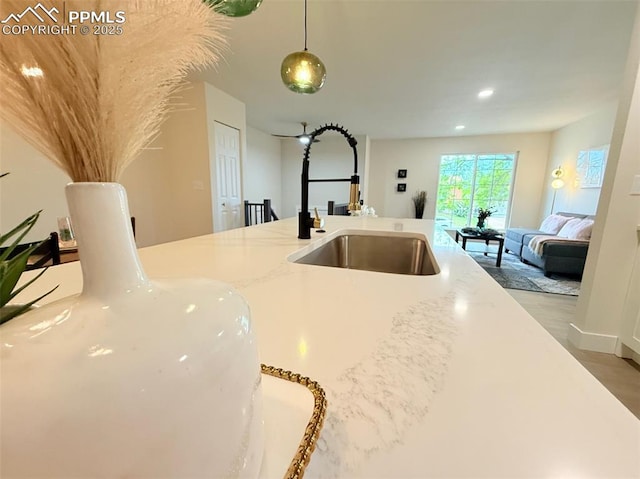 4770 Newton Dr, Colorado Springs, CO 80916 - kitchen featuring a sink, open floor plan, pendant lighting, light stone counters, and recessed lighting