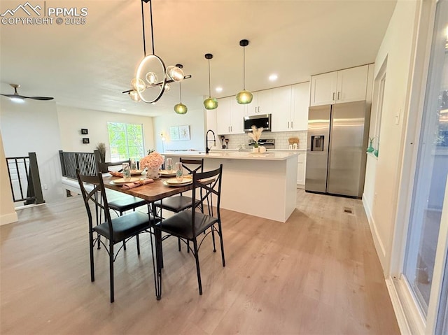 4770 Newton Dr, Colorado Springs, CO 80916 - dining room featuring light wood finished floors, baseboards, a chandelier, and recessed lighting