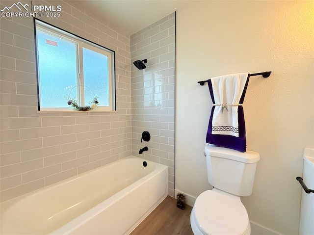 4770 Newton Dr, Colorado Springs, CO 80916 - full bathroom featuring toilet, wood finished floors, shower / bathtub combination, and baseboards
