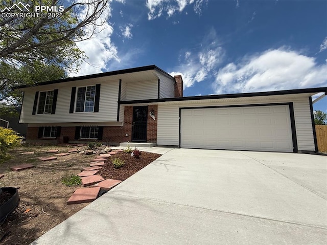 4770 Newton Dr, Colorado Springs, CO 80916 - split level home featuring concrete driveway, a garage, and brick siding