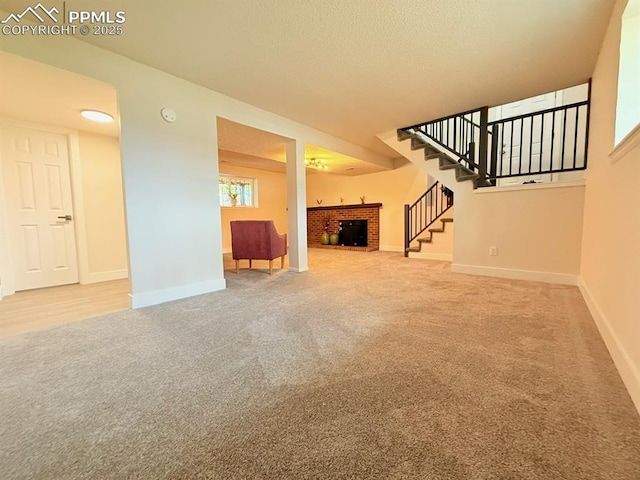 4770 Newton Dr, Colorado Springs, CO 80916 - unfurnished living room with carpet floors, a fireplace, stairway, and baseboards