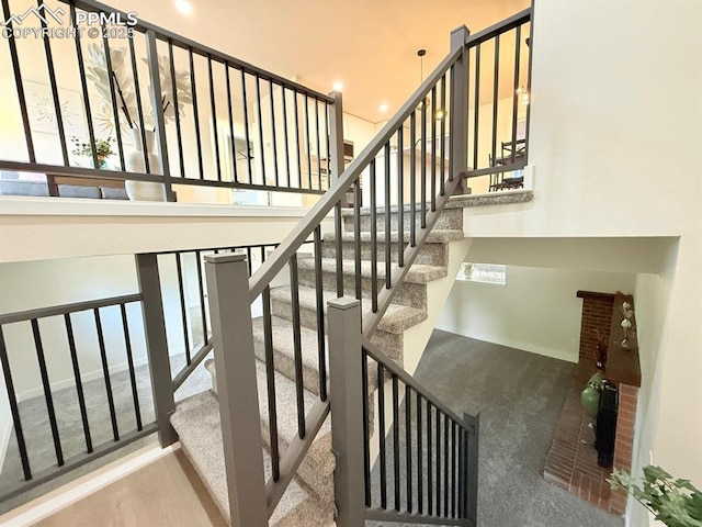 4770 Newton Dr, Colorado Springs, CO 80916 - stairs featuring carpet flooring and a towering ceiling