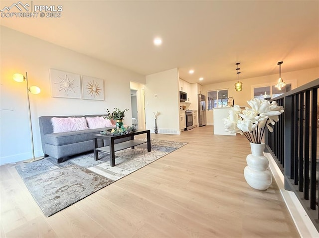 4770 Newton Dr, Colorado Springs, CO 80916 - living room featuring light wood-style floors, baseboards, and recessed lighting