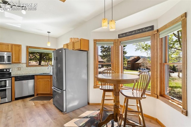 802 Red Eagle Ct, Woodland Park, CO 80863 - kitchen with stainless steel appliances, plenty of natural light, light wood-style flooring, and backsplash