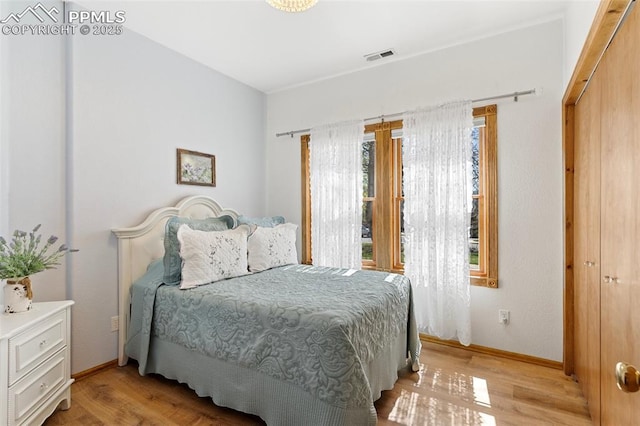 802 Red Eagle Ct, Woodland Park, CO 80863 - bedroom featuring light wood finished floors and baseboards