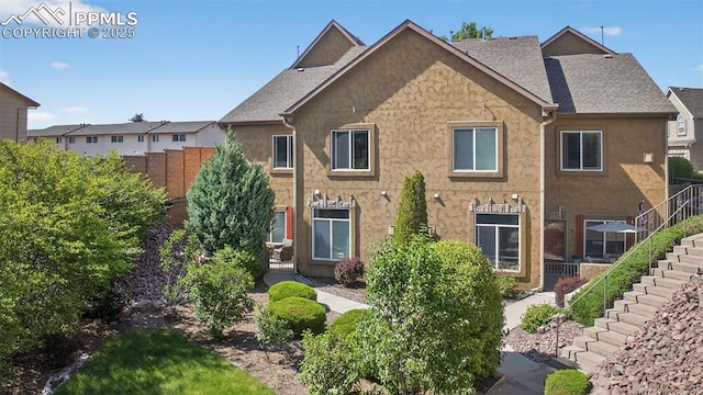 6678 Bethesda Pt Unit C, Colorado Springs, CO 80918 - view of front of home featuring stairs, stucco siding, and a shingled roof