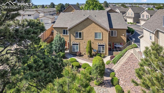 6678 Bethesda Pt Unit C, Colorado Springs, CO 80918 - view of front of home with a residential view, stucco siding, stairs, and a shingled roof