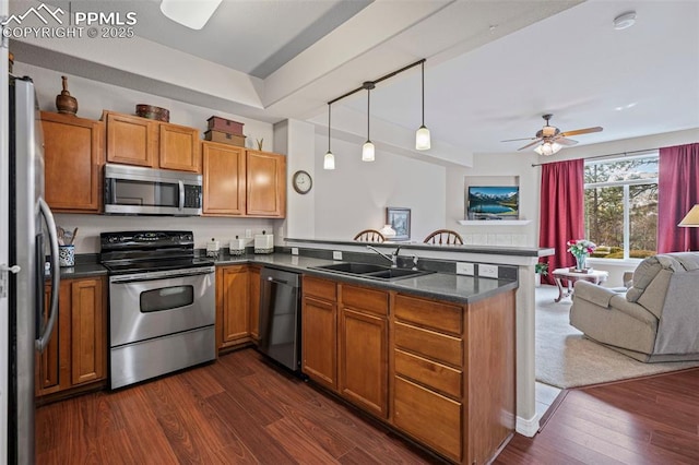 6678 Bethesda Pt Unit C, Colorado Springs, CO 80918 - kitchen with appliances with stainless steel finishes, open floor plan, a peninsula, dark countertops, and a ceiling fan