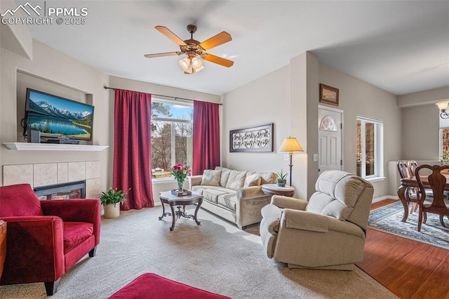 6678 Bethesda Pt Unit C, Colorado Springs, CO 80918 - living area featuring a fireplace, a ceiling fan, and wood finished floors