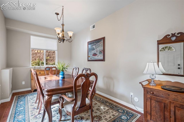 6678 Bethesda Pt Unit C, Colorado Springs, CO 80918 - dining room featuring a chandelier and wood finished floors