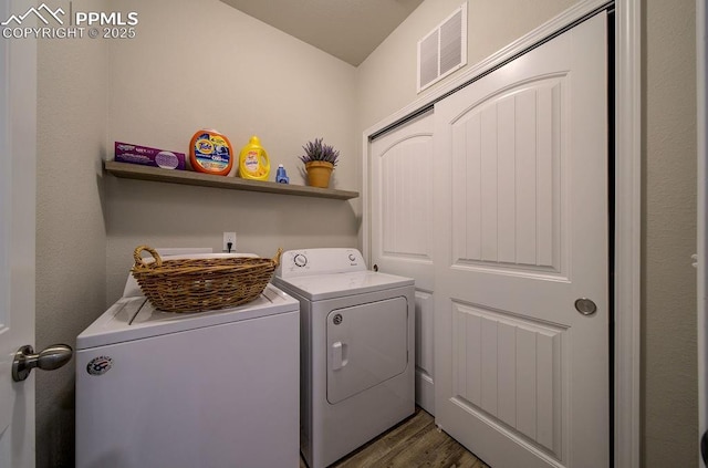 10144 Bluffstone Ct, Peyton, CO 80831 - laundry area with washer and clothes dryer and dark wood finished floors