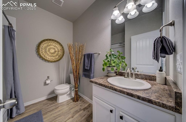 10144 Bluffstone Ct, Peyton, CO 80831 - full bath featuring vanity, wood finished floors, toilet, baseboards, and a shower with shower curtain