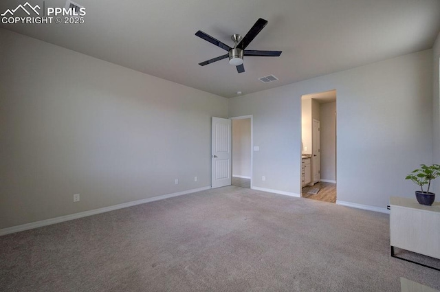 10144 Bluffstone Ct, Peyton, CO 80831 - unfurnished bedroom featuring light carpet, baseboards, connected bathroom, and ceiling fan