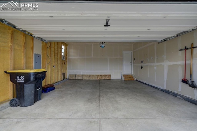 10144 Bluffstone Ct, Peyton, CO 80831 - garage featuring electric panel and a garage door opener