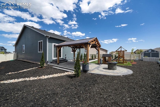 10144 Bluffstone Ct, Peyton, CO 80831 - rear view of property with a gazebo, a playground, a fenced backyard, and a patio area