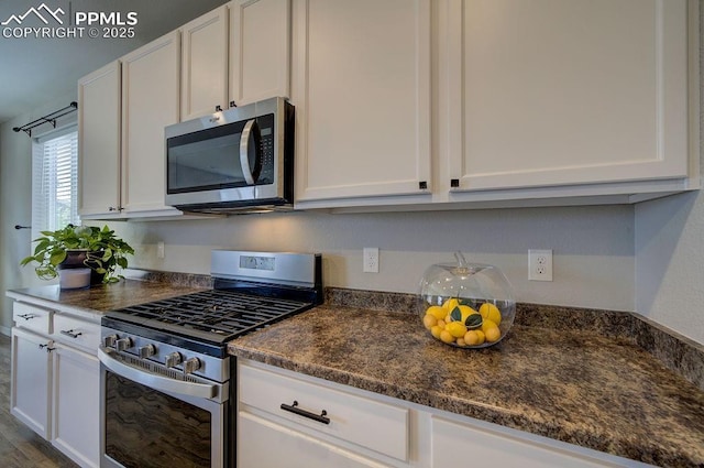10144 Bluffstone Ct, Peyton, CO 80831 - kitchen featuring appliances with stainless steel finishes and white cabinetry