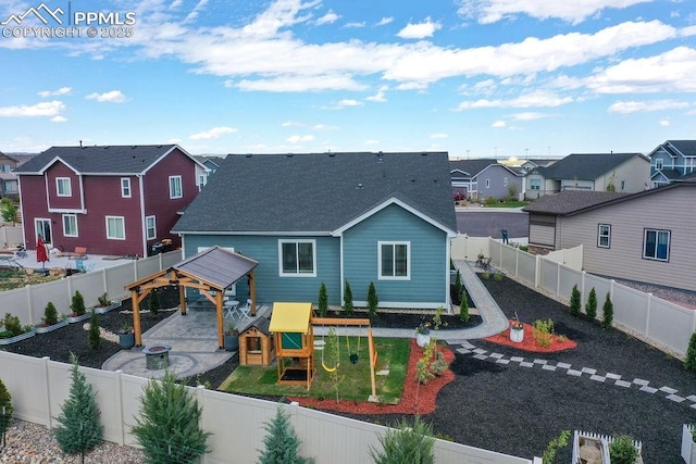 10144 Bluffstone Ct, Peyton, CO 80831 - back of house with a residential view, a playground, roof with shingles, and a fenced backyard