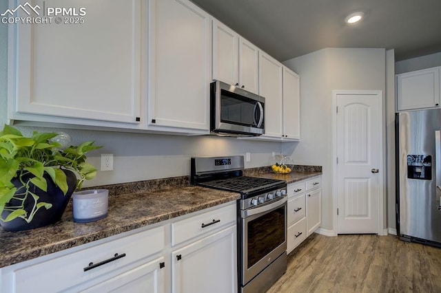 10144 Bluffstone Ct, Peyton, CO 80831 - kitchen with stainless steel appliances, white cabinetry, light wood-type flooring, and recessed lighting