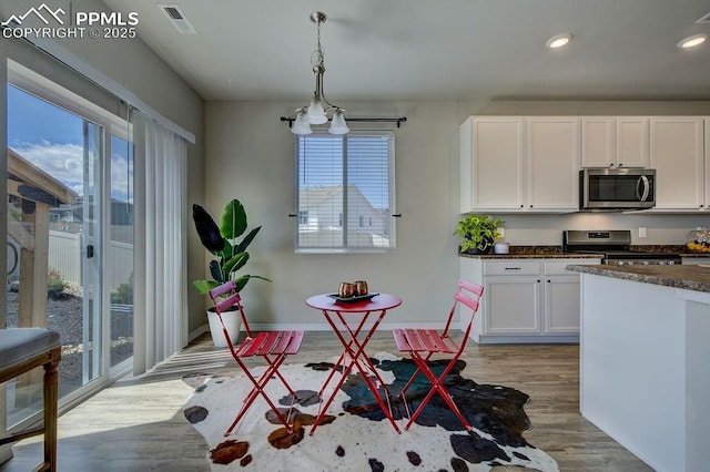 10144 Bluffstone Ct, Peyton, CO 80831 - dining room featuring light wood-style flooring, baseboards, and recessed lighting