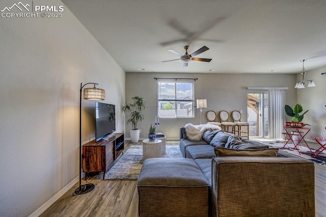 10144 Bluffstone Ct, Peyton, CO 80831 - living room featuring dark wood-style flooring, plenty of natural light, baseboards, and a ceiling fan